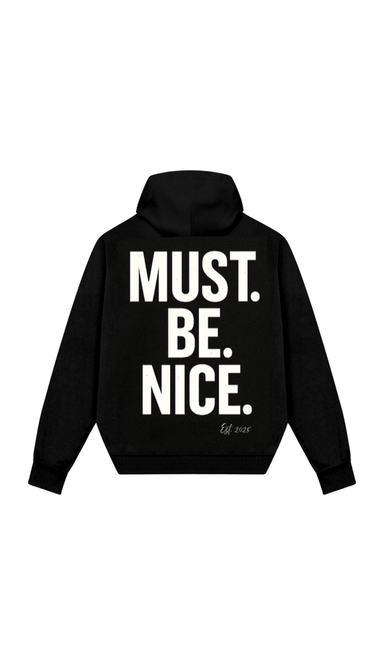 Black hoodie with 'MUST. BE. NICE.' text on the back against a white background